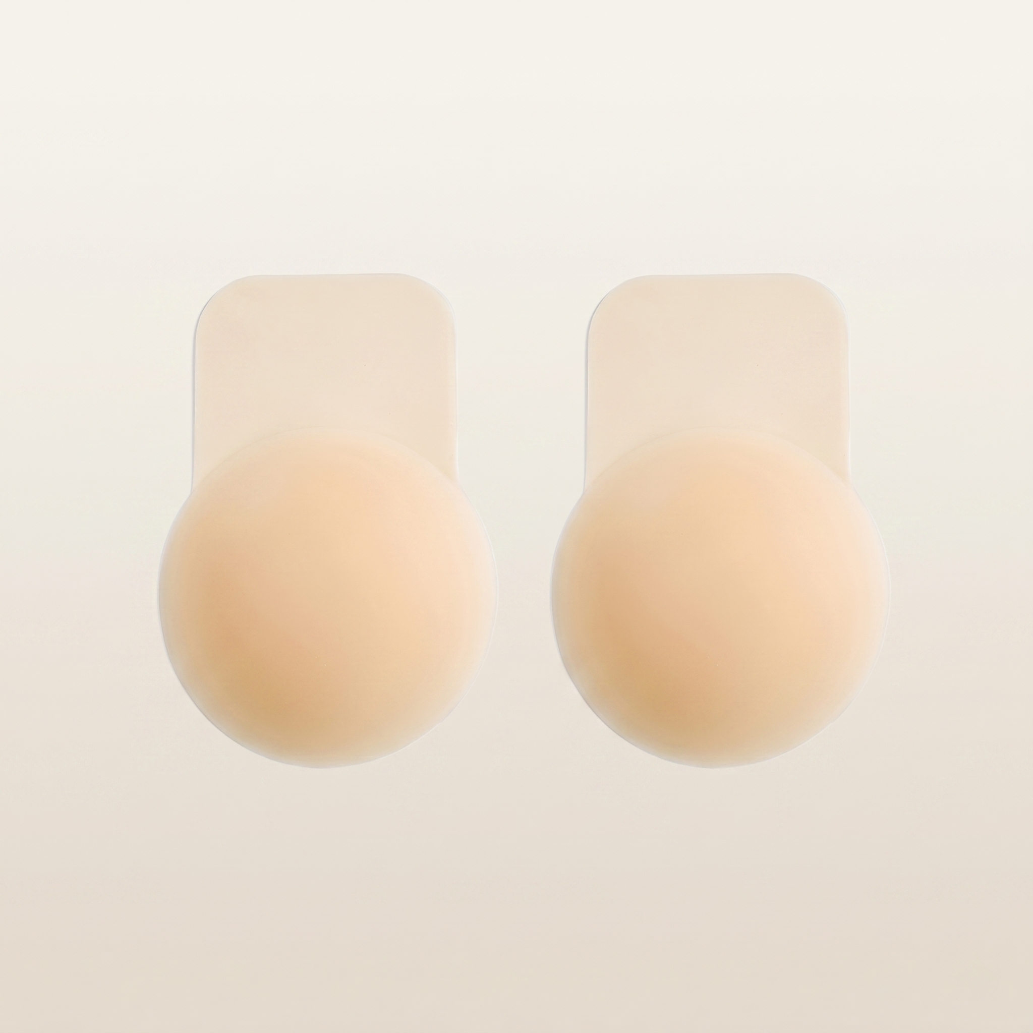 The Lift Nipple Cover, a nude silicone petal nipple cover with a lift tab